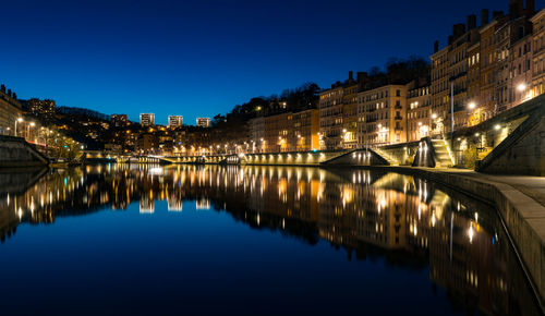 Reflection of illuminated buildings in river at night