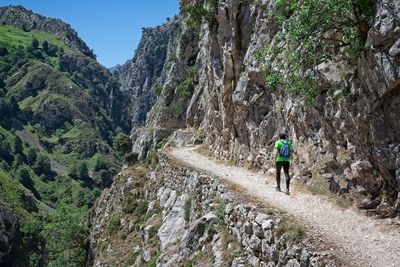 Full length rear view of man walking on mountain