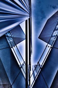 Low angle view of modern building against cloudy sky