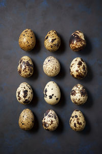 Quail eggs on a black table.