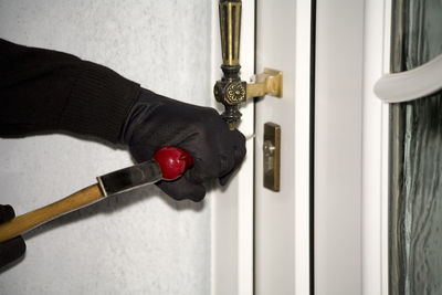 Burglary,hand with gloves on door, close-up
