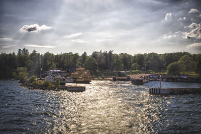 Scenic view of river against cloudy sky