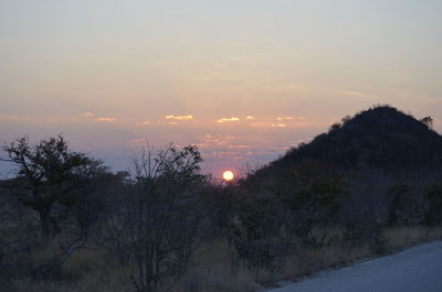 Scenic view of landscape against sky at sunset