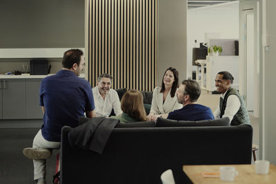 Group of business people having meeting in lobby