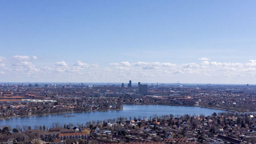 High angle view of townscape by sea against sky