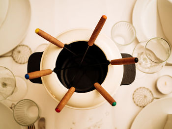 Directly above shot of spoons in container on table