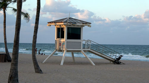 Lifeguard hut on beach against sky