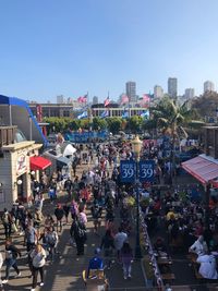 Group of people in city against buildings