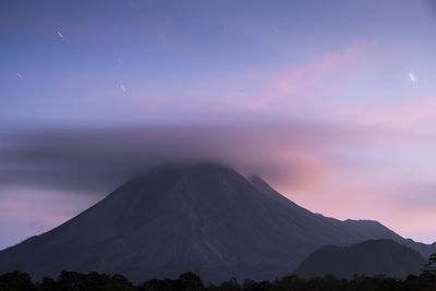 Scenic view of mountains against sky at sunset