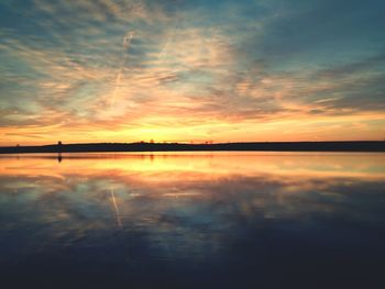 Scenic view of lake at sunset