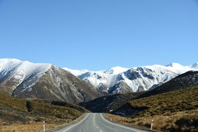 Scenic view of mountains against clear blue sky