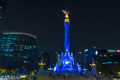 Statue of illuminated city at night