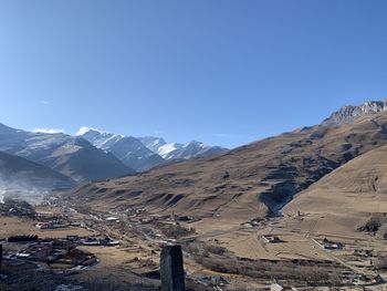 Scenic view of snowcapped mountains against clear blue sky