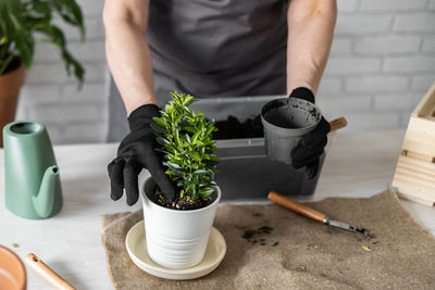 Midsection of man working on table