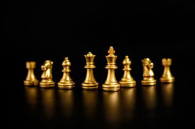 Close-up of chess pieces against black background