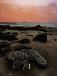 Scenic view of beach against sky during sunset