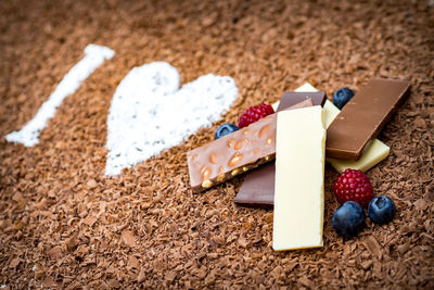 Close-up of multi colored candies on sand
