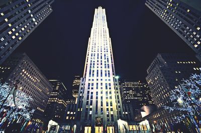 Low angle view of modern skyscraper at night