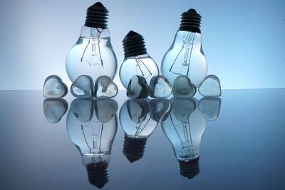 Heart shape ices and water in light bulbs on glass table