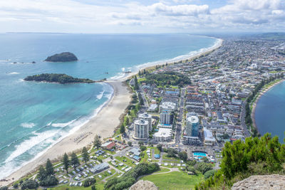 High angle view of sea and buildings against sky