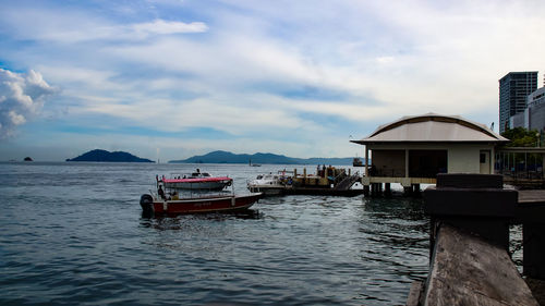 Scenic view of sea and buildings against sky