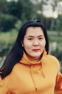 Portrait of young woman standing outdoors