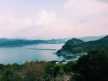 Scenic view of sea and mountains against sky