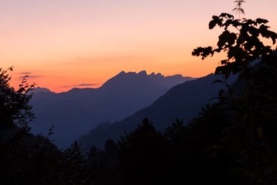 Scenic view of silhouette mountains against sky at sunset