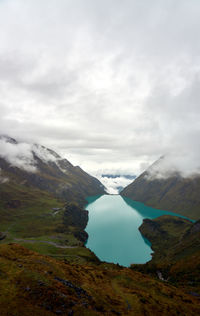 Scenic view of mountains against cloudy sky