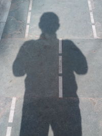 High angle view of shadow on street in city