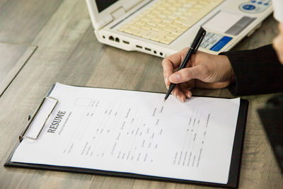 High angle view of man reading book on table