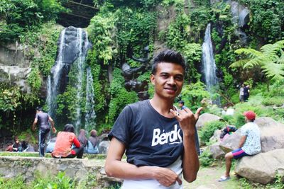 Portrait of smiling young man in forest