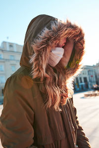 Midsection of woman standing in city