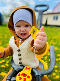 Portrait of cute girl holding hat