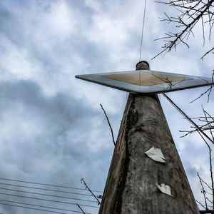 Low angle view of traditional windmill against sky