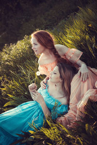 High angle view of young women sitting on grass