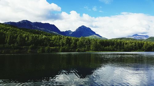 Scenic view of slipper lake by mountains against sky