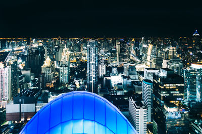 High angle view of illuminated buildings in city at night