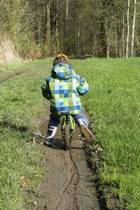 Rear view of man with umbrella on grass