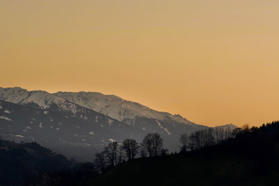 Scenic view of silhouette mountains against sky during sunset