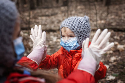 Cute kids wearing mask playing outdoors