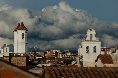 View of bell towers against cloudy sky