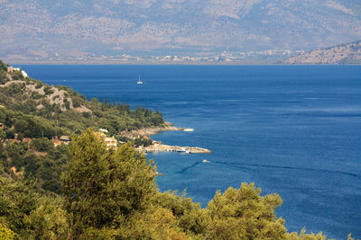 View of calm sea against mountain range