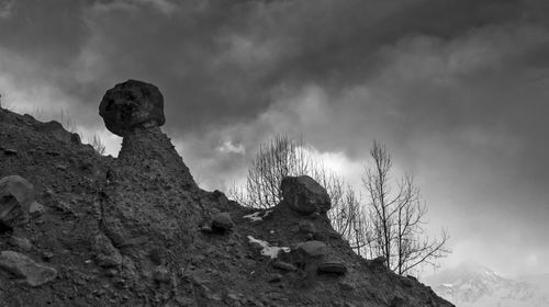 Low angle view of rock formation against sky