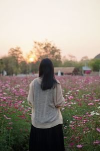 Rear view of woman standing against sky