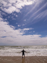 Man standing on beach against sky