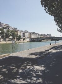 Calm river with buildings in background