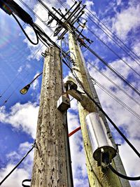 Low angle view of power line against blue sky