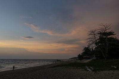 Scenic view of beach against sky during sunset