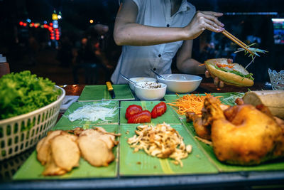 Man preparing food on table at market